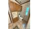 Functional bathroom featuring a toilet, storage shelves, and a window at 400 Archibald Rd, Concord, NC 28025