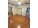 A large bedroom showcasing hardwood floors and views into two other rooms at 400 Archibald Rd, Concord, NC 28025