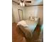 This is a bedroom with a ceiling fan, wood flooring, a door, and a neatly made bed at 400 Archibald Rd, Concord, NC 28025