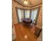 Charming dining area with wood table, natural light from surrounding windows, and warm wooden floors at 400 Archibald Rd, Concord, NC 28025