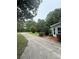 Features a long driveway leading to a charming home exterior with manicured landscaping and mature trees, offering privacy at 400 Archibald Rd, Concord, NC 28025