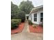 Inviting home exterior featuring manicured landscaping, a cozy entryway, and vibrant mulch beds enhancing curb appeal at 400 Archibald Rd, Concord, NC 28025
