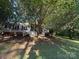 Home exterior features a screened in porch, with mature trees providing ample shade at 400 Archibald Rd, Concord, NC 28025