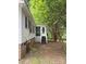 Cozy home exterior featuring a screened porch and natural landscaping, perfect for outdoor relaxation at 400 Archibald Rd, Concord, NC 28025