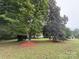 Spacious front yard with mature trees shading the single-story home at 400 Archibald Rd, Concord, NC 28025