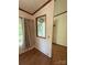 View of a charming hallway with an ornate mirror and hardwood flooring at 400 Archibald Rd, Concord, NC 28025