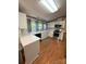 Bright kitchen featuring stainless steel appliances, white cabinets, and ample countertop space for meal preparation at 400 Archibald Rd, Concord, NC 28025