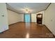 Open-concept living room with hardwood floors, fireplace, and sliding doors to the outdoor deck at 400 Archibald Rd, Concord, NC 28025