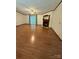 Spacious living room with ample natural light, hardwood floors, a ceiling fan, and a cozy fireplace at 400 Archibald Rd, Concord, NC 28025