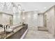 Modern bathroom with double sinks, stone accent wall, and contemporary design, featuring a large mirror at 435 S Tryon St, Charlotte, NC 28202