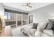 Bright bedroom with a ceiling fan, neutral walls, and large windows offering city views at 435 S Tryon St, Charlotte, NC 28202