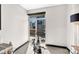 Bright room with exercise bike and a large window with views of the surrounding buildings at 435 S Tryon St, Charlotte, NC 28202