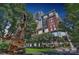 Beautiful brick building and park area with statues and lush landscaping on a sunny day at 435 S Tryon St, Charlotte, NC 28202