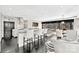 Open living area with kitchen bar, chairs, dark wood floors, white accents and expansive city views at 435 S Tryon St, Charlotte, NC 28202