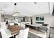 A modern living room and kitchen with stone accent wall, a linear fireplace and open floor plan at 435 S Tryon St, Charlotte, NC 28202