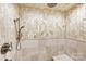 Modern walk-in shower featuring beautiful tilework, a hand-held shower head, and built-in bench at 435 S Tryon St, Charlotte, NC 28202