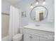 Bright bathroom featuring a shower/tub, classic white fixtures, and a round mirror at 4725 Rounding Run Rd, Charlotte, NC 28277