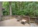 Relaxing outdoor deck area surrounded by lush trees and comfortable seating at 4725 Rounding Run Rd, Charlotte, NC 28277