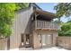 Side exterior of the property showcasing a balcony, a small patio, and doors leading inside the house at 4725 Rounding Run Rd, Charlotte, NC 28277