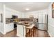Spacious kitchen with stainless steel appliances, island with seating, and decorative backsplash at 4725 Rounding Run Rd, Charlotte, NC 28277