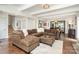 Open concept living room with hardwood floors and large brown sofa; dining area visible in the background at 4725 Rounding Run Rd, Charlotte, NC 28277