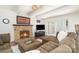 Cozy living room with a stone fireplace, modern TV, plush furniture, and access to the outside patio at 4725 Rounding Run Rd, Charlotte, NC 28277