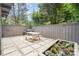 Outdoor patio with stone tiles, a grill, a picnic table, a fence and a raised garden bed with flowers at 4725 Rounding Run Rd, Charlotte, NC 28277