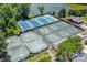 Aerial view of community tennis courts with a clubhouse, parking and landscaping at 4725 Rounding Run Rd, Charlotte, NC 28277