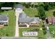 Aerial view of a home with detached garage featuring a well-manicured lawn and landscaped flowerbeds in Charlotte, NC at 5817 Red Carriage Ln, Charlotte, NC 28212