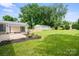 Beautiful backyard with a detached garage, privacy fence, manicured lawn, and mulch flower beds with nice landscaping at 5817 Red Carriage Ln, Charlotte, NC 28212