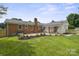 Expansive backyard featuring lush lawn, brick accents, and well-maintained landscaping, ideal for outdoor enjoyment at 5817 Red Carriage Ln, Charlotte, NC 28212