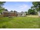Spacious backyard featuring lush lawn, brick accents, and well-maintained landscaping, ideal for outdoor enjoyment at 5817 Red Carriage Ln, Charlotte, NC 28212