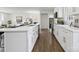 Well-lit kitchen featuring an island with a sink and breakfast bar, stainless steel appliances, and hardwood floors at 5817 Red Carriage Ln, Charlotte, NC 28212