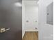 Functional laundry room with hardwood floors, neutral walls, and essential connections for appliances at 5817 Red Carriage Ln, Charlotte, NC 28212