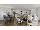 Bright open-concept living space with hardwood floors and plenty of seating, flowing to dining area and kitchen at 5817 Red Carriage Ln, Charlotte, NC 28212