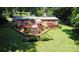 A beautiful backyard features a deck, manicured lawn, and garden at 5832 Thompson Rd, Charlotte, NC 28216