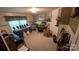 A bedroom space is furnished with tables, chairs, and shelves displaying jewelry and decorative items at 5832 Thompson Rd, Charlotte, NC 28216
