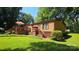 Home exterior showcasing a spacious deck, well-maintained lawn, and inviting curb appeal at 5832 Thompson Rd, Charlotte, NC 28216