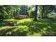 Charming home with lush lawn and mature trees creating a serene, park-like setting at 5832 Thompson Rd, Charlotte, NC 28216