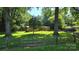 This home features a picturesque yard and a charming wooden fence, offering a serene, tree-lined view at 5832 Thompson Rd, Charlotte, NC 28216