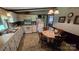Cozy kitchen with white appliances, tile floor, breakfast nook, and laminate countertop at 5832 Thompson Rd, Charlotte, NC 28216