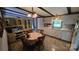Kitchen with white cabinetry, tiled backsplash, dining table, and overhead lighting at 5832 Thompson Rd, Charlotte, NC 28216