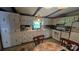 Cozy kitchen with white appliances, tile floor, breakfast nook, and laminate countertop at 5832 Thompson Rd, Charlotte, NC 28216