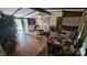 Open floor plan with a dining table and views into a cozy living room with beamed ceilings at 5832 Thompson Rd, Charlotte, NC 28216