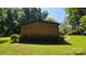 Side view of home on a beautiful lot with mature trees and landscaping at 5832 Thompson Rd, Charlotte, NC 28216