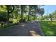 A street view of the property with mature trees and a lush lawn at 5832 Thompson Rd, Charlotte, NC 28216