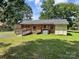 Brick home with an accessible ramp, green grass, and storage shed at 613 Catawba St, Chester, SC 29706