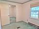 Bedroom featuring a mirrored closet, a window with blinds, and carpet at 613 Catawba St, Chester, SC 29706