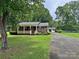 Charming brick home with a covered front porch, lush lawn, and a detached garage at 613 Catawba St, Chester, SC 29706