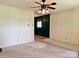 Spacious living room with carpet, a ceiling fan, and a glimpse into the adjacent dining area at 613 Catawba St, Chester, SC 29706